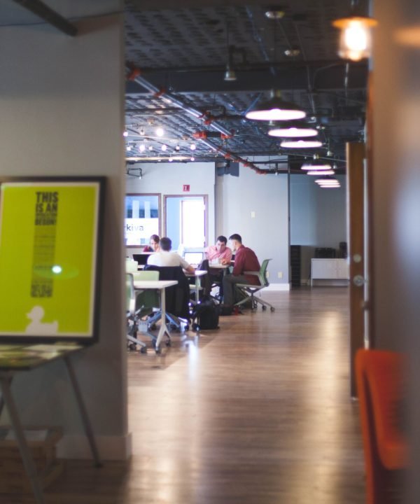 Contemporary open office space with people collaborating and working together.